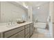 Bathroom featuring double sinks with white countertops and cabinetry, large mirror and soaking tub at 205 Coxe Ave, Charlotte, NC 28208