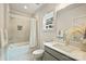Bathroom featuring a tub with tile surround, single sink vanity and modern fixtures at 205 Coxe Ave, Charlotte, NC 28208