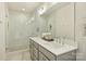 Well-lit bathroom showcasing double sink vanity, decorative plants, large mirror and glass shower at 205 Coxe Ave, Charlotte, NC 28208