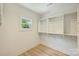 Walk-in closet with wood floors, a window, and shelving and clothing rods on multiple walls at 205 Coxe Ave, Charlotte, NC 28208