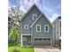 Charming two-story home featuring a gray exterior, a well-manicured lawn, and an attached garage, blending comfort with curb appeal at 205 Coxe Ave, Charlotte, NC 28208