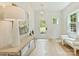 Inviting foyer boasts a light-filled space with white walls, wood floors, stylish lighting, and an exterior view at 205 Coxe Ave, Charlotte, NC 28208