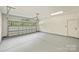 Spacious two car garage featuring epoxy floor, modern lighting, and automatic door at 205 Coxe Ave, Charlotte, NC 28208