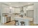 Modern kitchen features white cabinets, stainless steel appliances, a center island with seating, and sleek countertops at 205 Coxe Ave, Charlotte, NC 28208