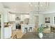 Open layout featuring a modern kitchen with a central island, stainless steel appliances, and a seamless transition to living spaces at 205 Coxe Ave, Charlotte, NC 28208