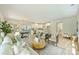 Open-concept living space with hardwood floors, a stylish seating area, and a view of the modern kitchen and dining space at 205 Coxe Ave, Charlotte, NC 28208