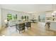 Bright living area with light wood floors, white walls, large windows, and a seamless flow into the dining area and kitchen at 205 Coxe Ave, Charlotte, NC 28208