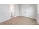 Bright bedroom with hardwood floors, closet, and doorway to a bathroom at 208 Mattoon St, Charlotte, NC 28216