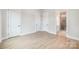 Well-lit bedroom featuring wood-style flooring, white doors, and a bathroom entrance at 208 Mattoon St, Charlotte, NC 28216