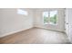 Spacious bedroom featuring hardwood floors, ample natural light, and large windows at 208 Mattoon St, Charlotte, NC 28216