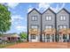 Rear exterior view of modern townhomes boasting private wooden balconies and well-maintained surroundings at 208 Mattoon St, Charlotte, NC 28216
