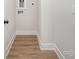 Clean hallway with wood-style flooring and white baseboards at 208 Mattoon St, Charlotte, NC 28216