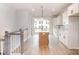 Elegant kitchen featuring white cabinets, quartz countertops, a center island, and open access to the balcony at 208 Mattoon St, Charlotte, NC 28216