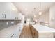 Modern kitchen with white and wood cabinets, quartz counters, a large island, and stainless steel faucet at 208 Mattoon St, Charlotte, NC 28216