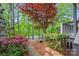 Backyard oasis with lush landscaping, patio area, and serene views, perfect for outdoor living and entertaining at 208 Wendover Heights Cir, Charlotte, NC 28211