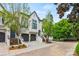Elegant home exterior with a well-manicured lawn, mature trees, and beautiful architectural details at 208 Wendover Heights Cir, Charlotte, NC 28211