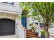 Stunning front entrance with brick steps, elegant railings, and a vibrant blue door at 208 Wendover Heights Cir, Charlotte, NC 28211