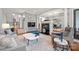 Bright and airy living room with a fireplace, hardwood floors, and large windows filling the space with natural light at 208 Wendover Heights Cir, Charlotte, NC 28211