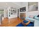 Bright open-concept living room features custom shelves, wine storage, and hardwood floors at 208 Wendover Heights Cir, Charlotte, NC 28211