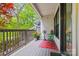 Charming porch featuring outdoor seating, decorative plants, and scenic views of the surrounding trees at 208 Wendover Heights Cir, Charlotte, NC 28211