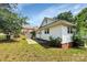 View of backyard with patio, partial fence, and mature landscaping offering privacy at 209 S Ransom St, Gastonia, NC 28052