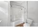 Bright bathroom featuring a tiled shower and toilet, providing a clean and functional space at 209 S Ransom St, Gastonia, NC 28052