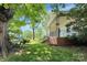 Exterior of a home with a front porch and mature trees at 209 S Ransom St, Gastonia, NC 28052
