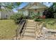 Charming single-story home featuring a blue front door, landscaped yard, and concrete steps at 209 S Ransom St, Gastonia, NC 28052