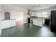 Open-concept kitchen with tile floors and a view into the dining area, ideal for modern living at 209 S Ransom St, Gastonia, NC 28052