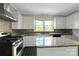 Efficient kitchen with granite countertops, an island, and modern appliances, perfect for cooking and entertaining at 209 S Ransom St, Gastonia, NC 28052