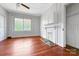 Versatile living room with hardwood floors, a fireplace, and a window, offering a cozy and inviting space at 209 S Ransom St, Gastonia, NC 28052