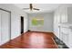 Bright living room with hardwood floors, ceiling fan, fireplace, and natural light at 209 S Ransom St, Gastonia, NC 28052