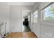This mudroom features vinyl tile flooring, a rear entry door and view into the adjacent kitchen at 209 S Ransom St, Gastonia, NC 28052