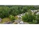 Stunning aerial view of a neighborhood featuring white homes surrounded by lush green trees and manicured lawns at 2535 Andes Dr, Statesville, NC 28625