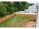 Spacious backyard showcasing a lush green lawn, a patio with seating, and a newly installed wooden fence at 2535 Andes Dr, Statesville, NC 28625