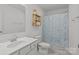Bright bathroom featuring floral shower curtain and a white vanity with sink at 2535 Andes Dr, Statesville, NC 28625
