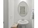 Elegant powder room features a pedestal sink and an oval decorative mirror at 2535 Andes Dr, Statesville, NC 28625