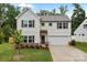 Charming two-story home with white siding, shutters, and a well-manicured lawn at 2535 Andes Dr, Statesville, NC 28625