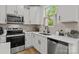 Close-up of the kitchen featuring stainless steel appliances and white countertops at 2535 Andes Dr, Statesville, NC 28625