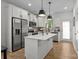 Bright kitchen featuring white cabinets, stainless steel appliances, and a center island at 2535 Andes Dr, Statesville, NC 28625