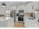 Bright kitchen featuring white cabinets, stainless steel appliances, and ample counter space at 2535 Andes Dr, Statesville, NC 28625