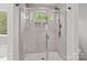 Modern shower with tiled walls, glass door and accent window at 2535 Andes Dr, Statesville, NC 28625