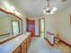 A spacious bathroom has a dual sink vanity, chandelier, and doorway to a walk-in closet at 2721 Tara Dr, Monroe, NC 28112