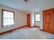 Neutral carpeted bedroom has multiple doors and windows at 2721 Tara Dr, Monroe, NC 28112