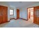 A carpeted bedroom is illuminated by natural light and features paneled doors and trim at 2721 Tara Dr, Monroe, NC 28112