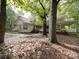 Charming home featuring mature trees, a brick facade, a white porch and a well landscaped yard at 2721 Tara Dr, Monroe, NC 28112