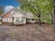 Spacious house featuring brick and white exterior, complete with an attached garage and mature trees at 2721 Tara Dr, Monroe, NC 28112