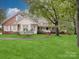 Charming home with manicured lawn, front porch, and a blend of brick and siding at 2721 Tara Dr, Monroe, NC 28112