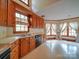 A kitchen with oak cabinets, lots of natural light, and tile flooring provides a functional cooking space at 2721 Tara Dr, Monroe, NC 28112