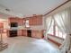 Spacious kitchen featuring oak cabinets and tile flooring, ready for renovation at 2721 Tara Dr, Monroe, NC 28112